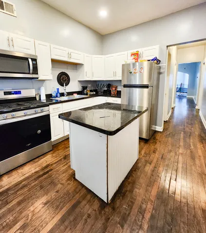 a kitchen with stainless steel appliances granite countertop a sink and cabinets