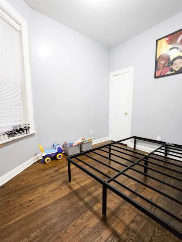 a view of a room with wooden floor and lounge chair