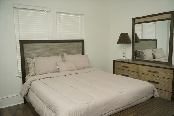 a bedroom with a bed and a night stand