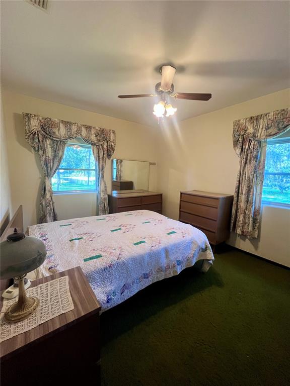 407 Hunting Lodge Drive Inverness, FL 34453 - Photo 11 of 16 a bed sitting in a bedroom next to a window