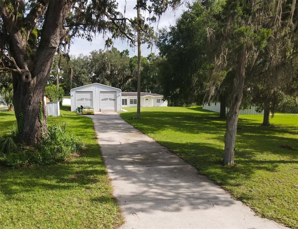 407 Hunting Lodge Drive Inverness, FL 34453 - Photo 2 of 16 a front view of a house with a yard