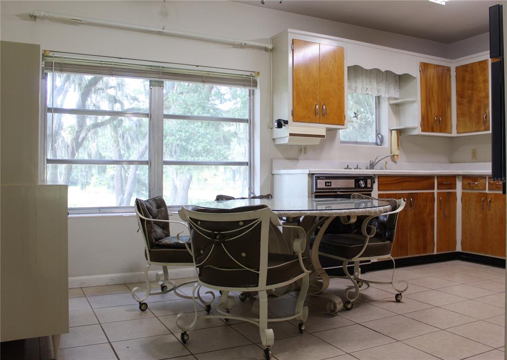 407 Hunting Lodge Drive Inverness, FL 34453 - Photo 7 of 16 a view of a dining room with furniture and a window