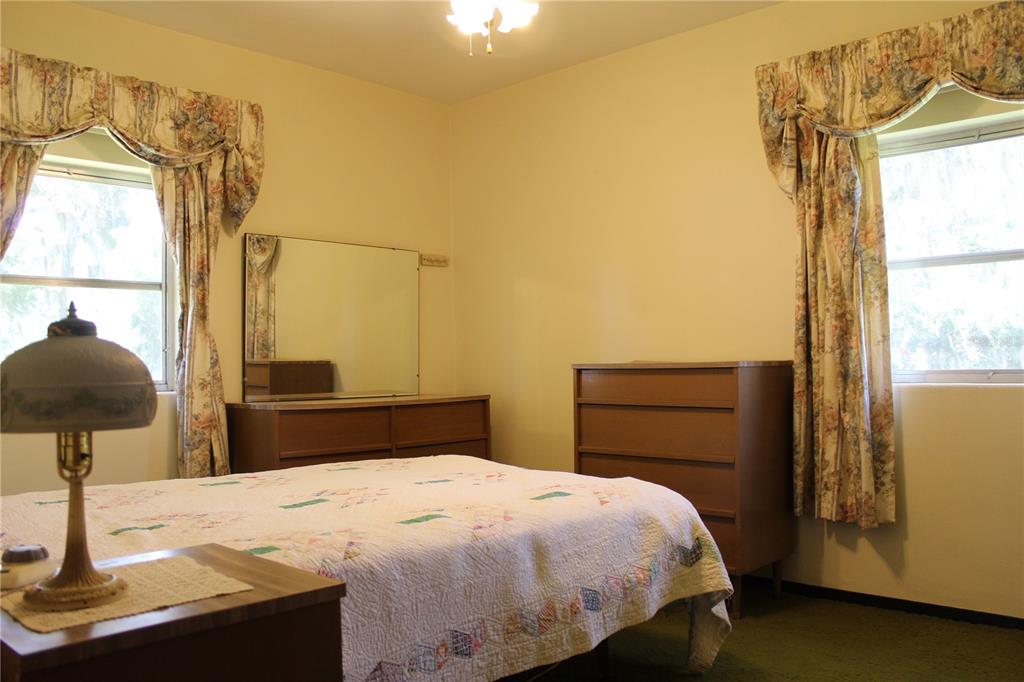 407 Hunting Lodge Drive Inverness, FL 34453 - Photo 10 of 16 a bedroom with a bed and a window