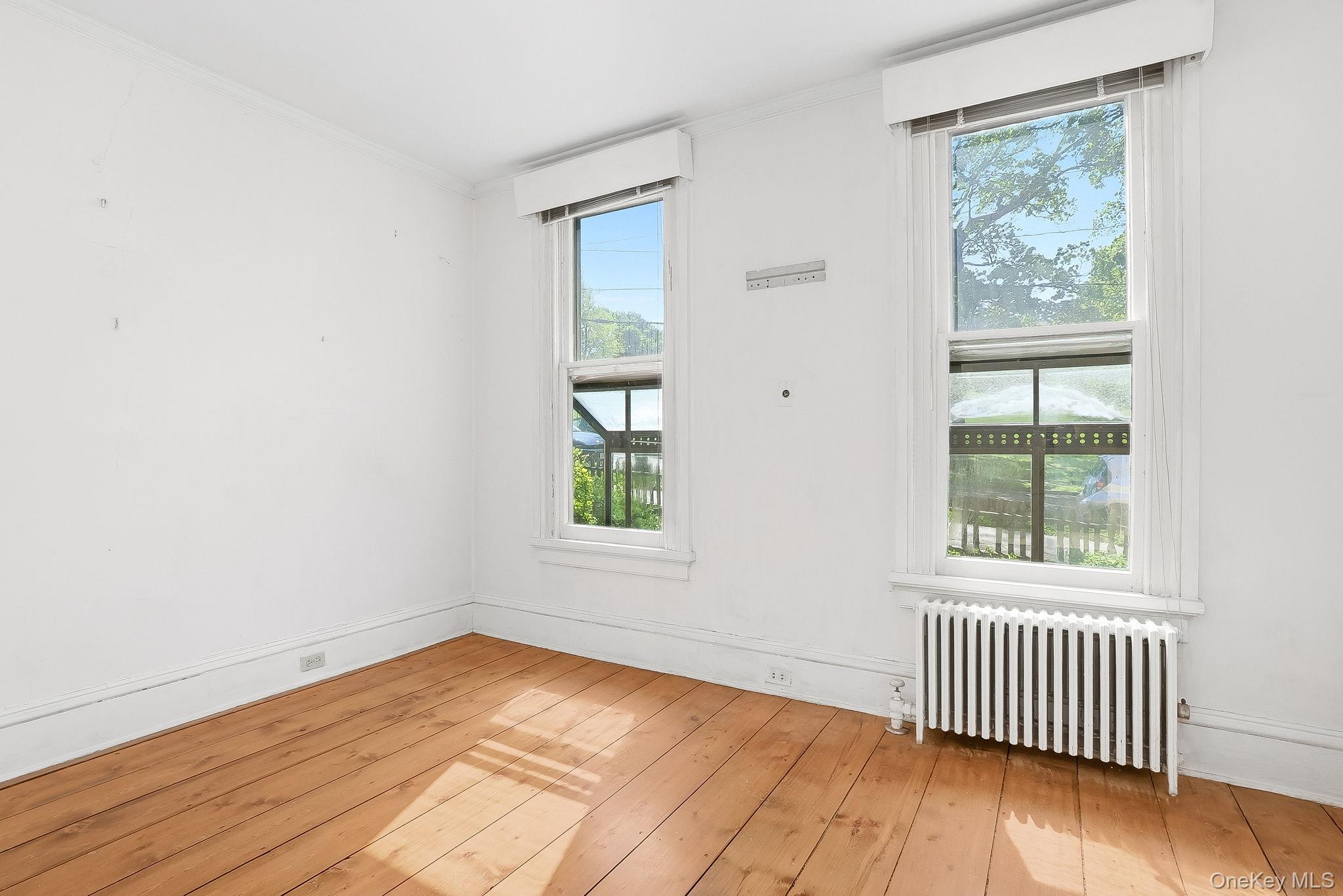 172 Main Street Cold Spring, NY 10516 - Photo 7 of 28 an empty room with wooden floor and windows