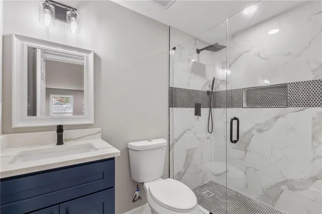 a bathroom with a sink toilet and shower
