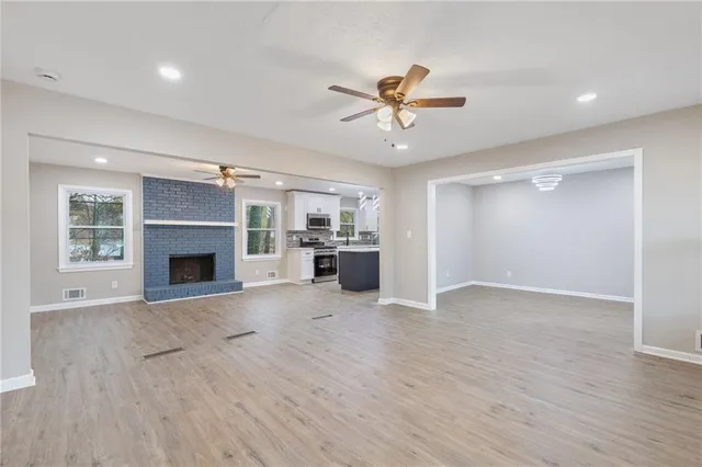 a view of a kitchen with a sink and a fireplace