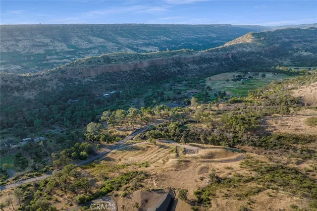 a view of a large mountain with mountains in the background