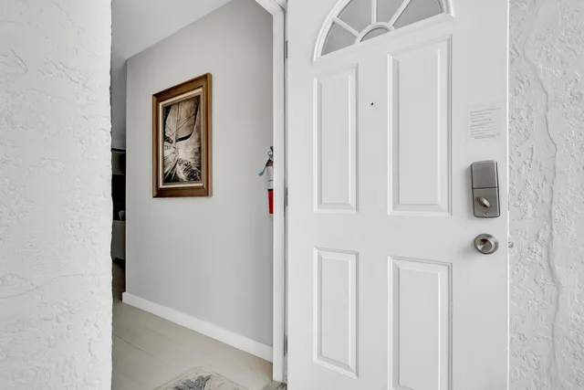 a view of a hallway with wooden floor and closet
