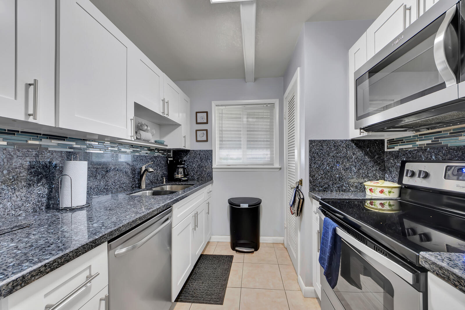 308 Sombrero Beach Road, Unit 1 & 3 Marathon, FL 33050 - Photo 29 of 36 a kitchen with stainless steel appliances granite countertop a sink stove and cabinets