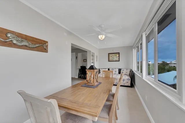 a living room with furniture and a ceiling fan