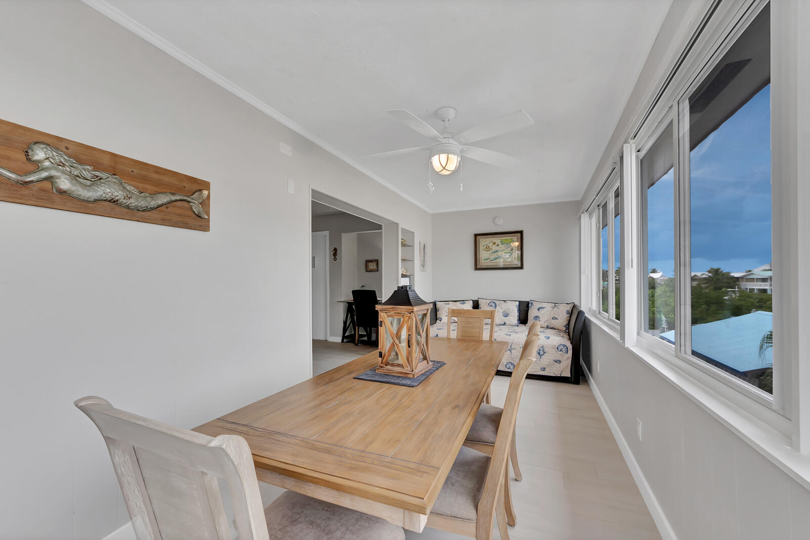 308 Sombrero Beach Road, Unit 1 & 3 Marathon, FL 33050 - Photo 9 of 36 a view of a dining room with furniture window and wooden floor