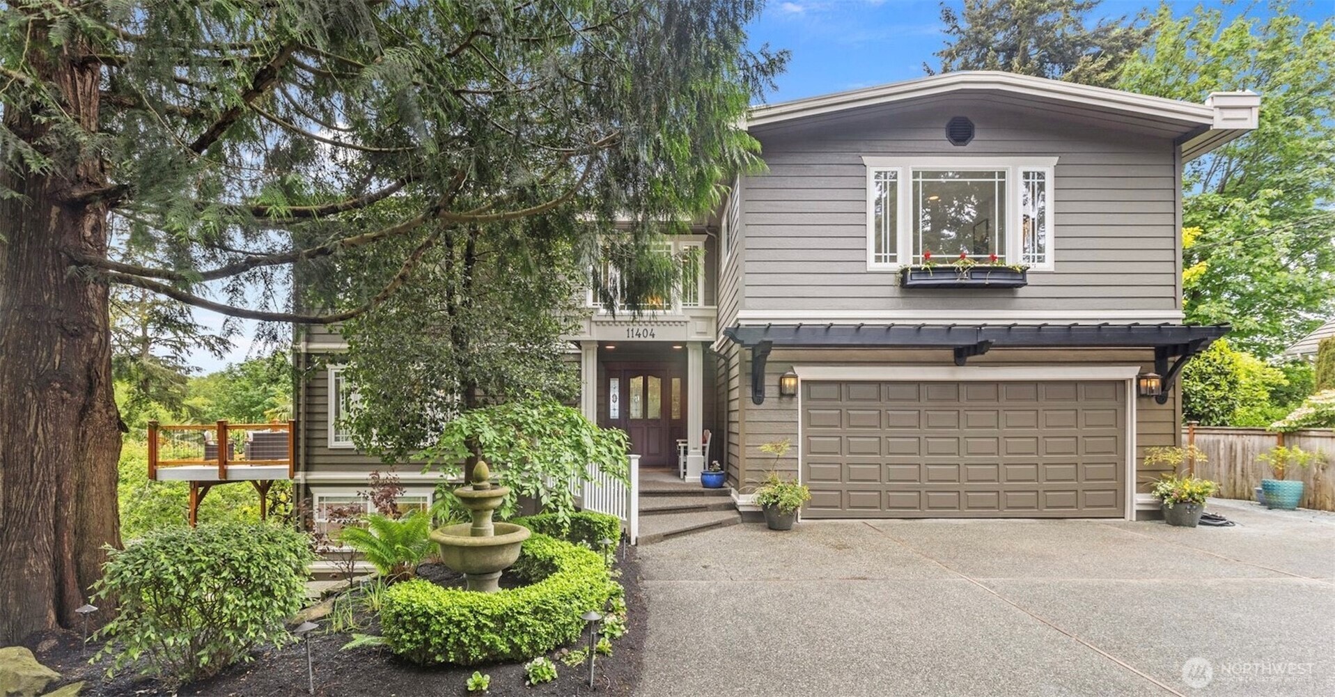a front view of a house with a yard garage and outdoor seating