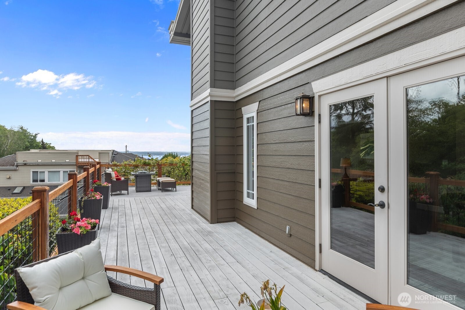 11404 239th Place Southwest Woodway, WA 98020 - Photo 13 of 40 a balcony with wooden floor and outdoor seating