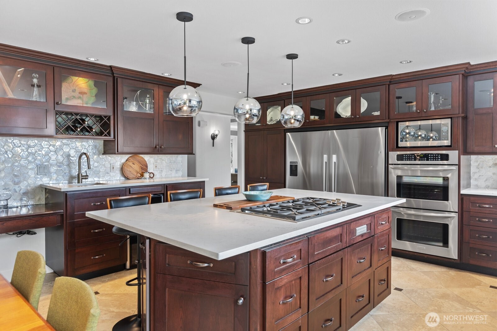 11404 239th Place Southwest Woodway, WA 98020 - Photo 7 of 40 a kitchen with a stove a kitchen island a cabinets and chairs