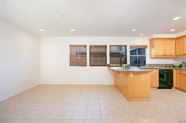 a view of kitchen with stainless steel appliances granite countertop sink and cabinets