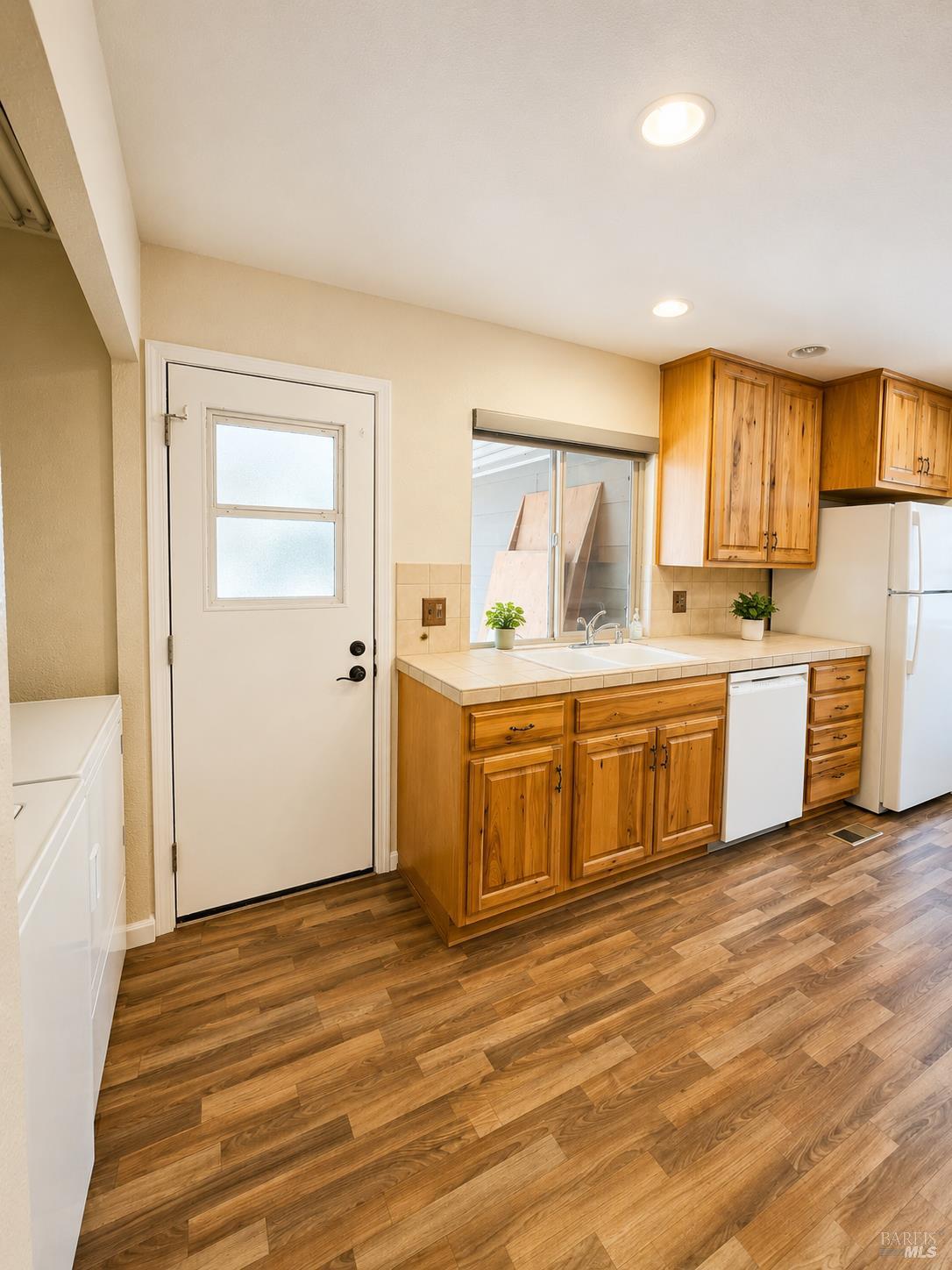 1945 Piner Road, Unit 16 Santa Rosa, CA 95403 - Photo 10 of 18 a room with a sink cabinets and wooden floor