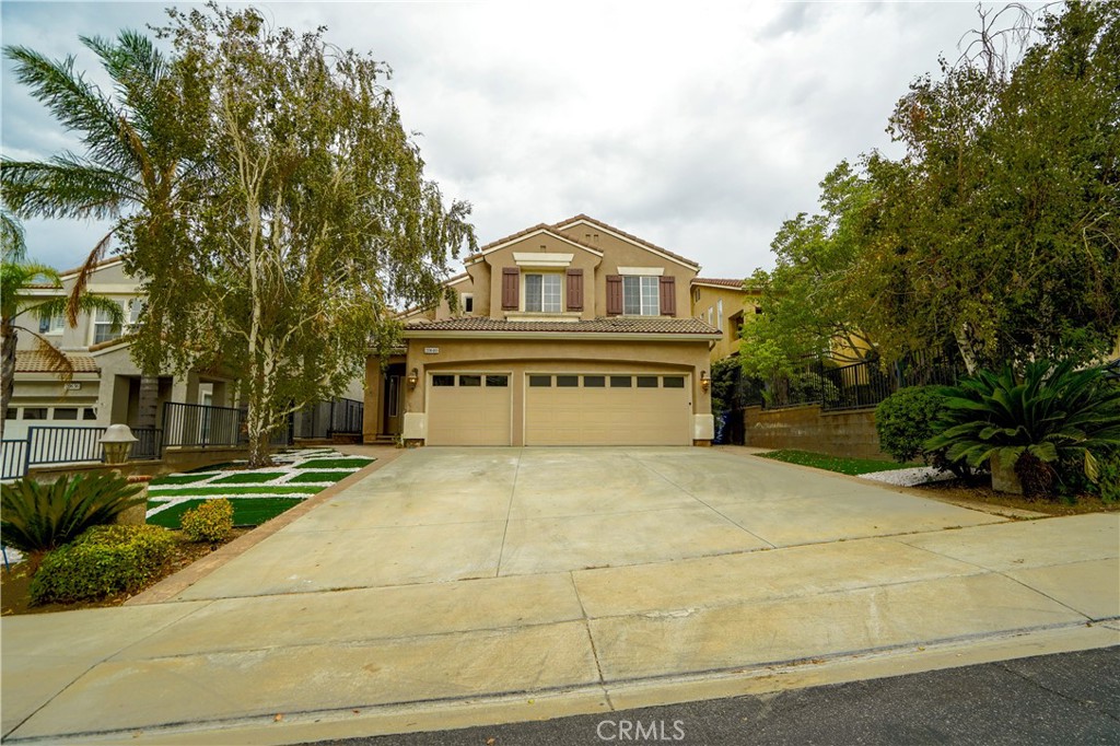 20640 Pesaro Way Porter Ranch, CA 91326 - Photo 1 of 1 a front view of a house with a yard