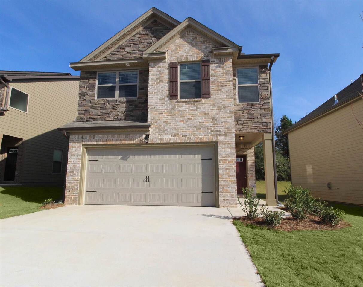 3506 Sycamore Bend, Unit 62 Decatur, GA 30034 - Photo 1 of 1 a front view of a house with a yard and garage