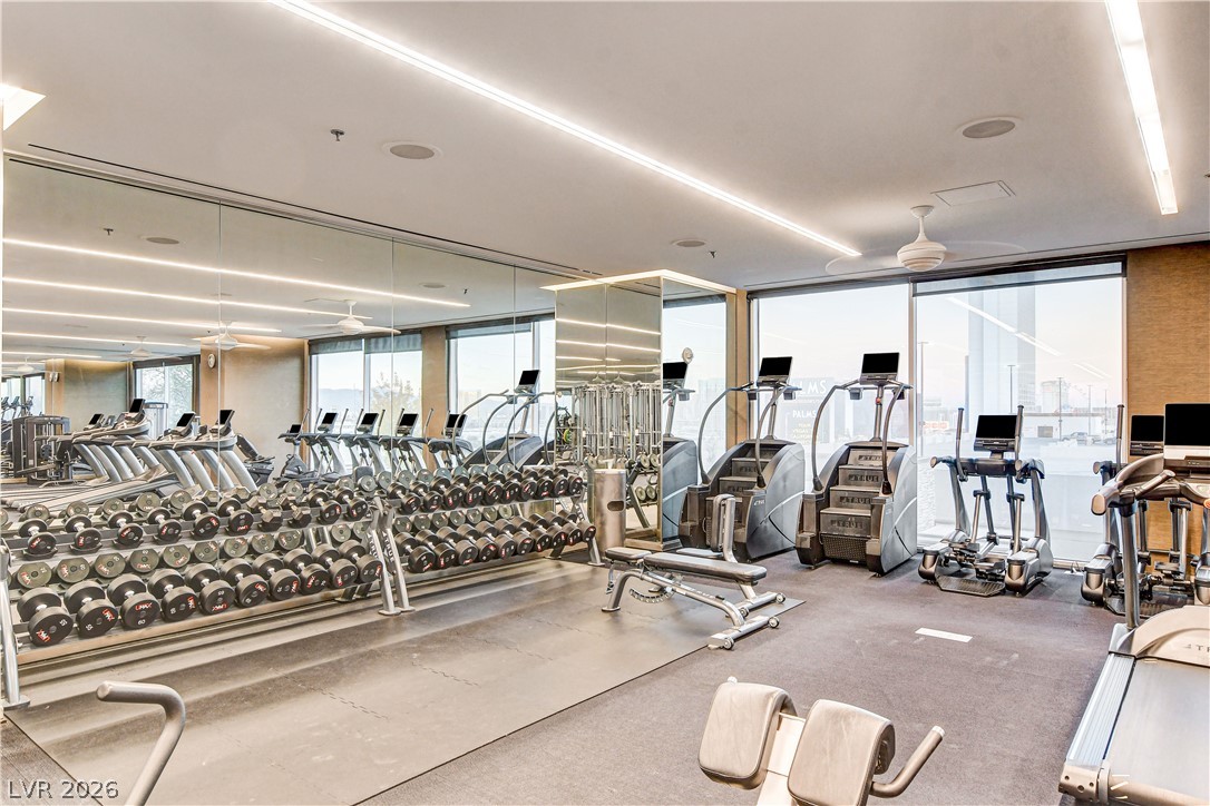 4381 West Flamingo Road, Unit 3002 Las Vegas, NV 89103 - Photo 28 of 59 Floor-to-ceiling windows and expansive mirrors define this professionally equipped fitness space.