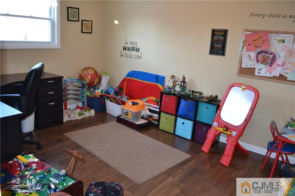 51 Eardley Road Edison, NJ 08817 - Photo 18 of 22 a view of a workspace with furniture and wooden floor