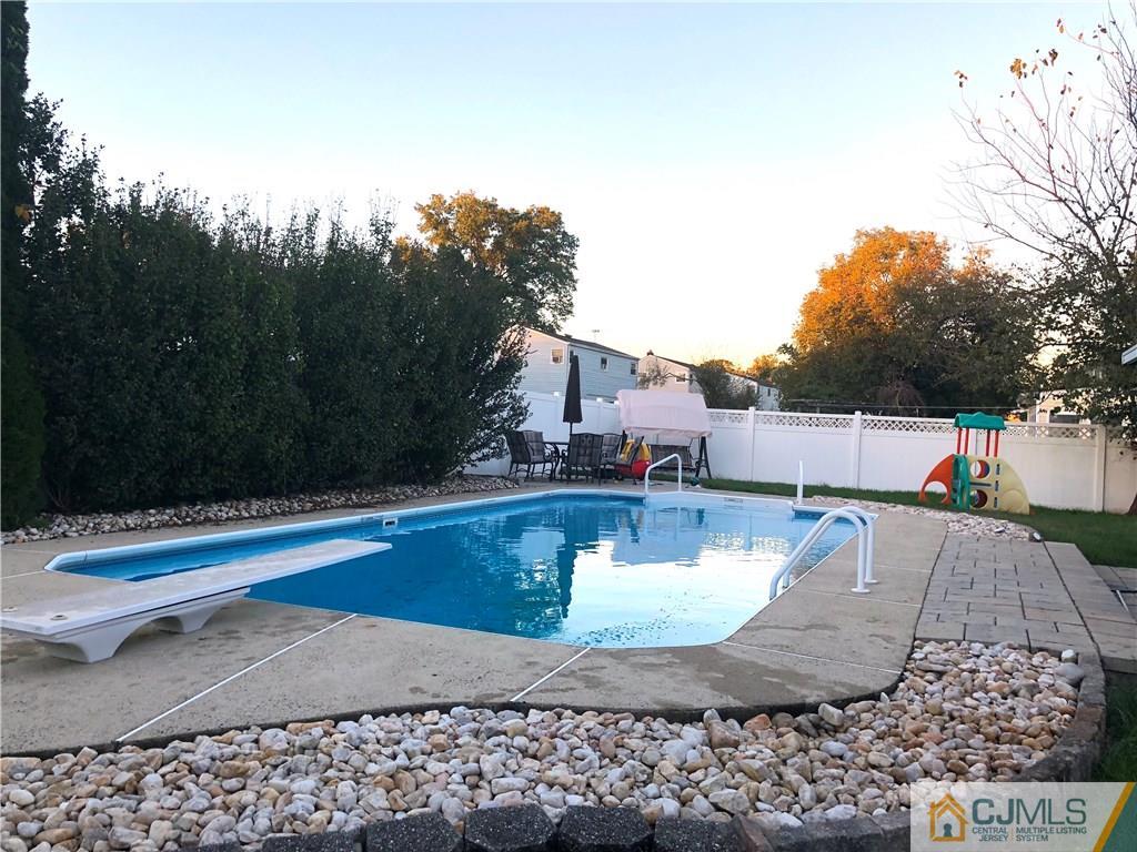 51 Eardley Road Edison, NJ 08817 - Photo 21 of 22 a view of a swimming pool with a patio