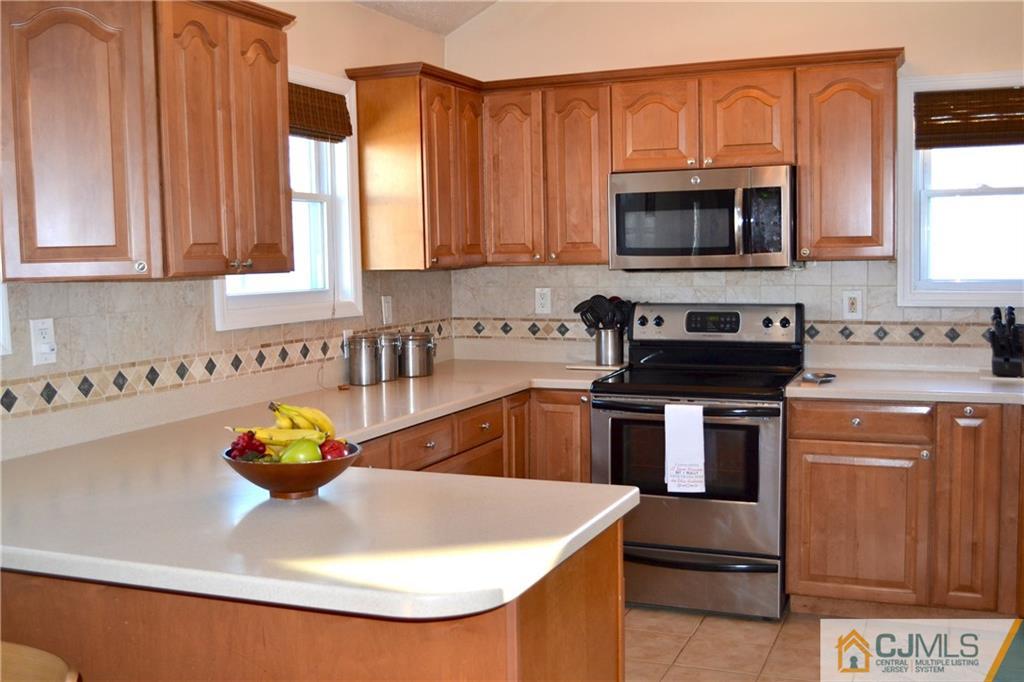 51 Eardley Road Edison, NJ 08817 - Photo 4 of 22 a kitchen with stainless steel appliances granite countertop a sink a stove and a microwave