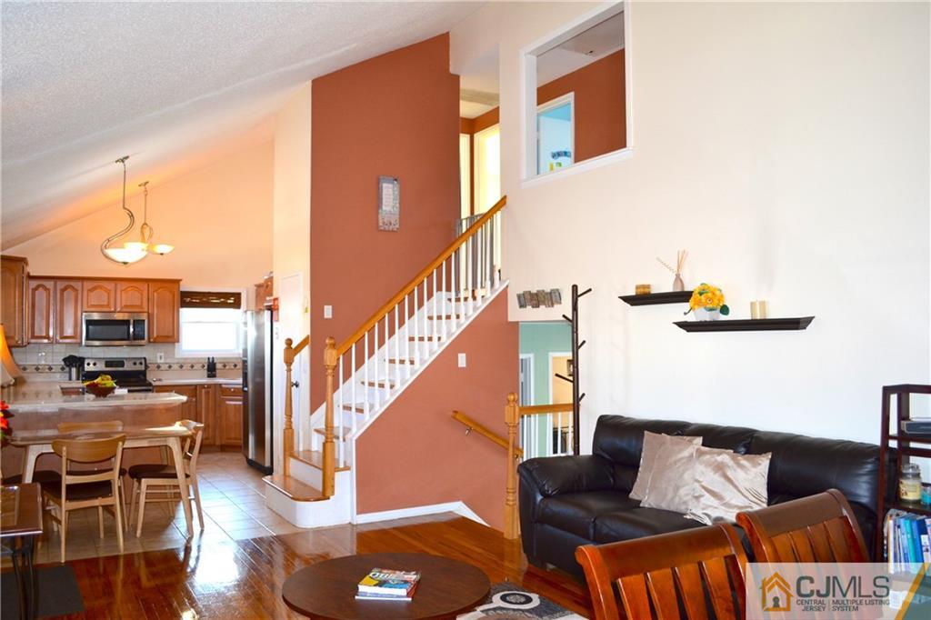 51 Eardley Road Edison, NJ 08817 - Photo 5 of 22 a living room with furniture and a kitchen view