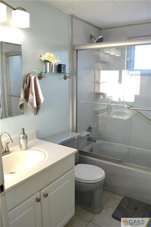 51 Eardley Road Edison, NJ 08817 - Photo 8 of 22 a bathroom with a toilet a sink and mirror