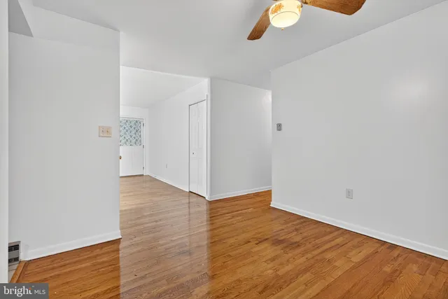 a view of an empty room with wooden floor