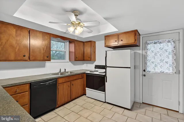 a kitchen with a refrigerator a sink and cabinets