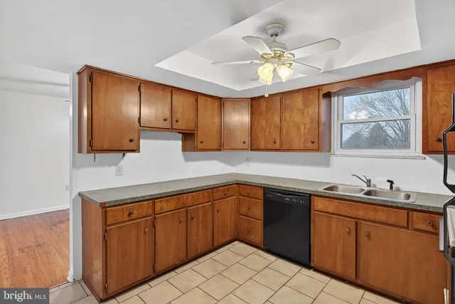 a kitchen with a sink cabinets and window
