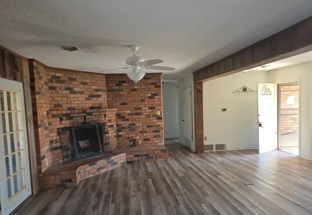 wooden floor in an empty room with a fireplace