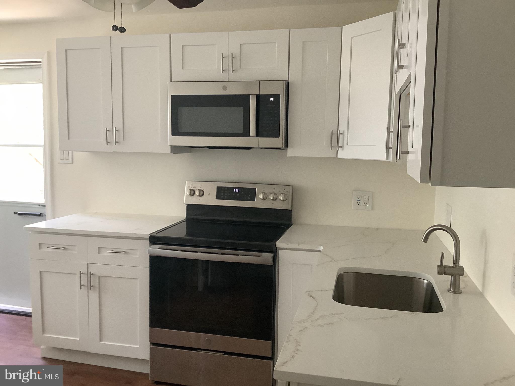 21 Davis Avenue Clementon, NJ 08021 - Photo 6 of 15 a kitchen with white cabinets and stainless steel appliances