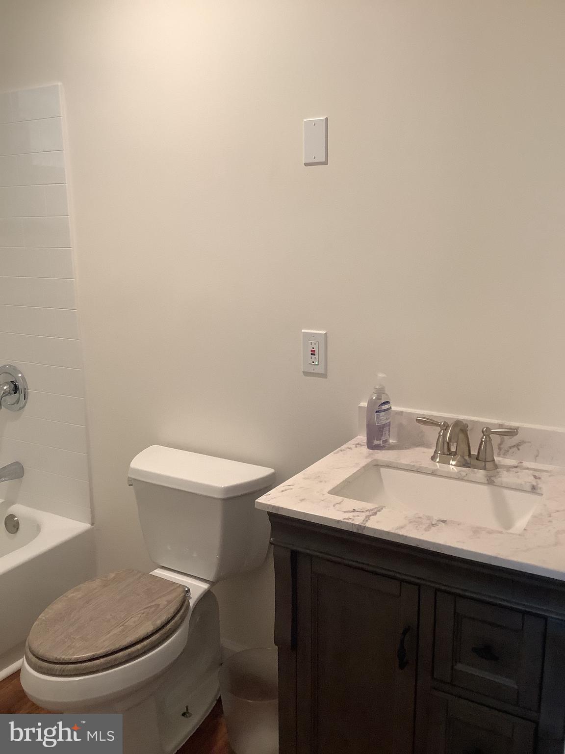 21 Davis Avenue Clementon, NJ 08021 - Photo 10 of 15 a white toilet sitting next to a bathroom sink