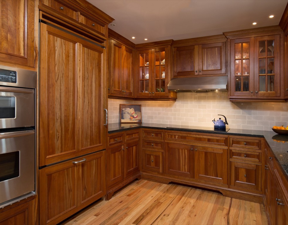 4 Gibson Road, Unit 2 Lexington, MA 02421 - Photo 3 of 10 a kitchen with kitchen island wooden cabinets stainless steel appliances a sink and a window