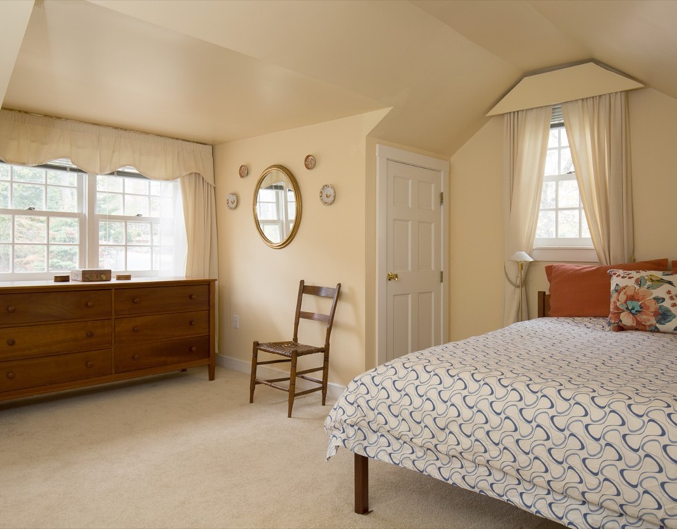 4 Gibson Road, Unit 2 Lexington, MA 02421 - Photo 8 of 10 a bedroom with a bed a window and dresser