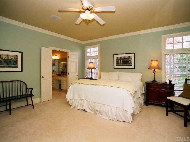 500 Wild Rose Court Raleigh, NC 27615 - Photo 8 of 12 a spacious bedroom with a bed and a chandelier