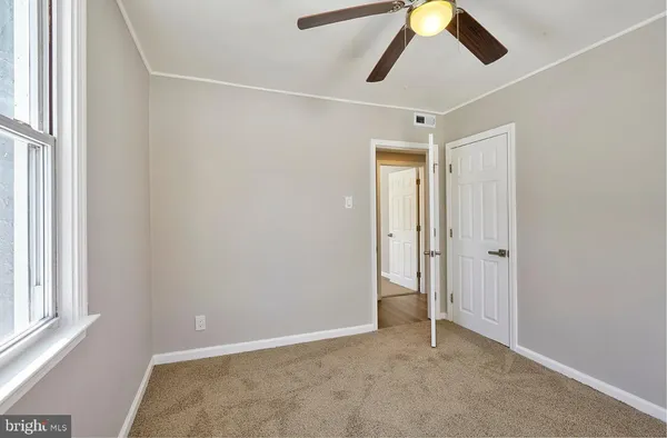a view of room with window and ceiling fan