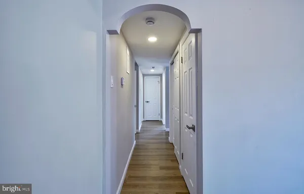 a view of a hallway with wooden floor