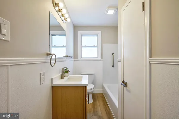 a bathroom with a sink a mirror and a shower