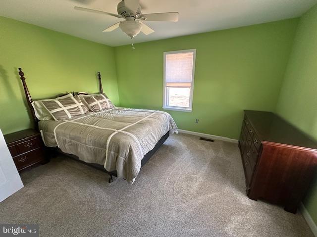 10116 Deal Island Road Deal Island, MD 21821 - Photo 16 of 30 a bed sitting in a bedroom next to a window