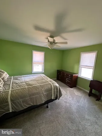 a bedroom with bed and a window