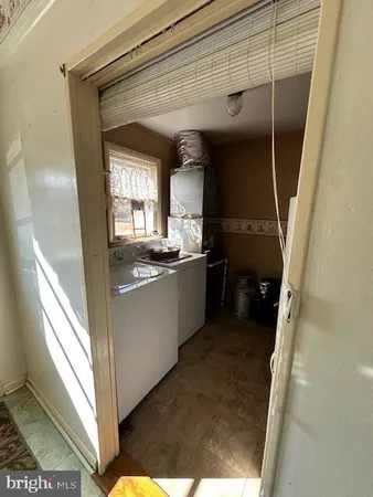 a kitchen with a sink a refrigerator and window
