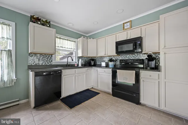 a kitchen with a sink stove top oven and refrigerator