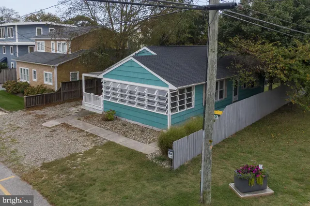 a view of a wooden house with a yard