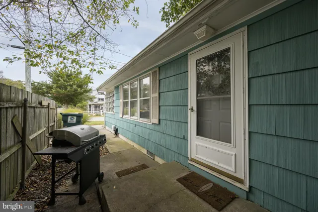 a view of a porch with furniture and floor to ceiling window