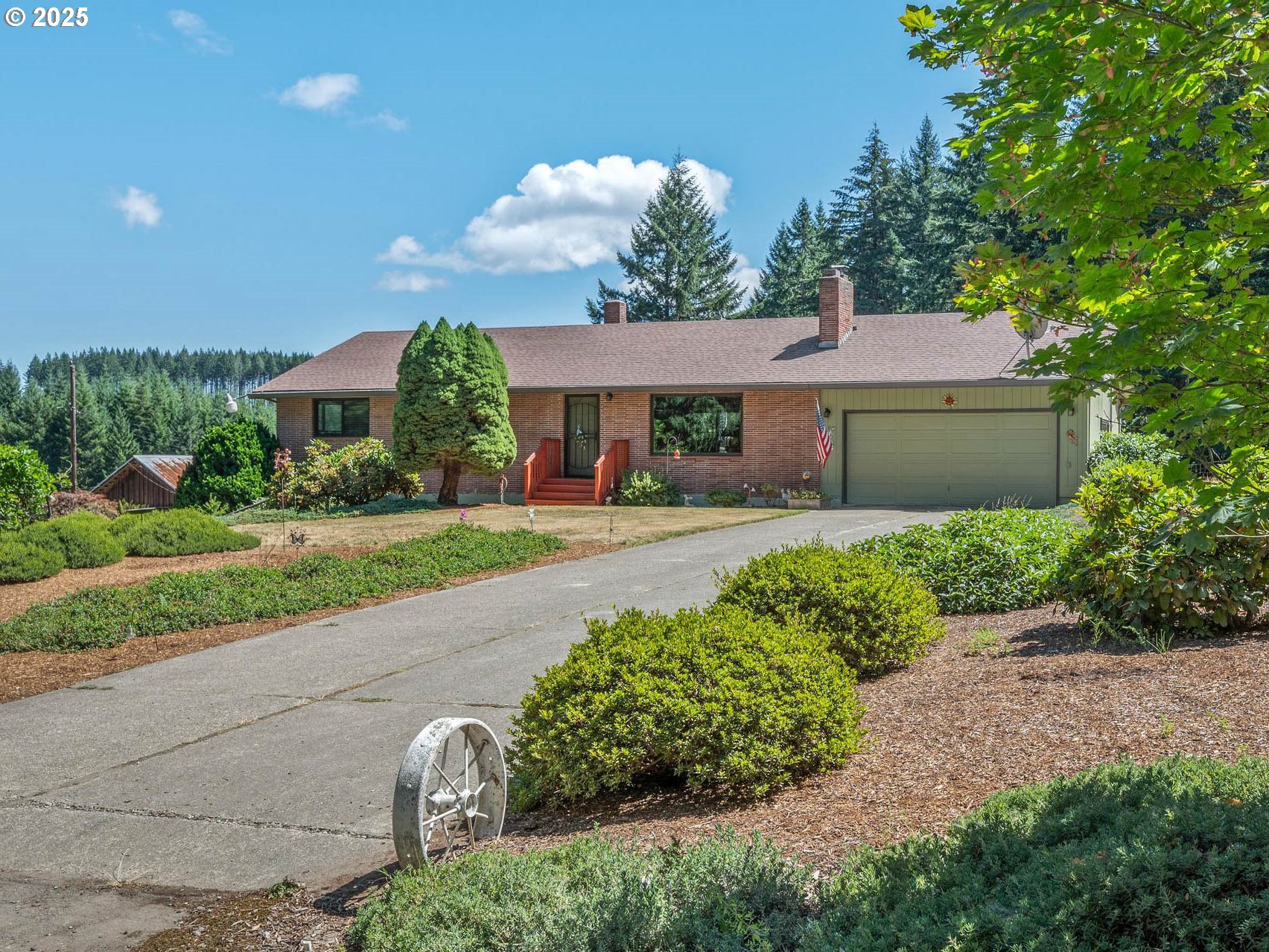 a front view of a house with a yard and potted plants