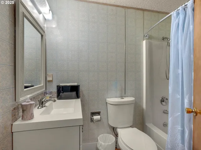 a bathroom with a toilet sink shower and mirror
