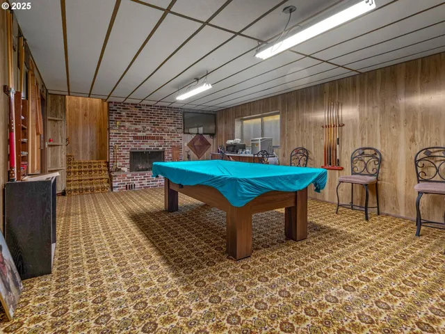 a room with pool table and windows