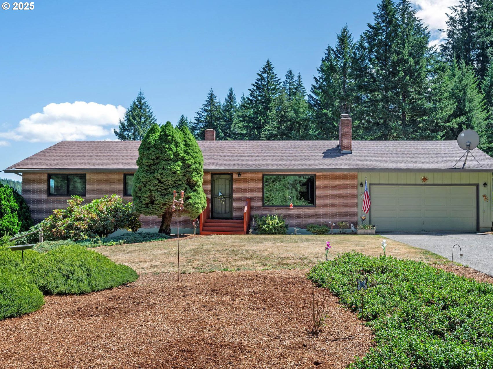 25420 Northwest Pumpkin Ridge Road North Plains, OR 97133 - Photo 19 of 41 a front view of a house with a yard and garage
